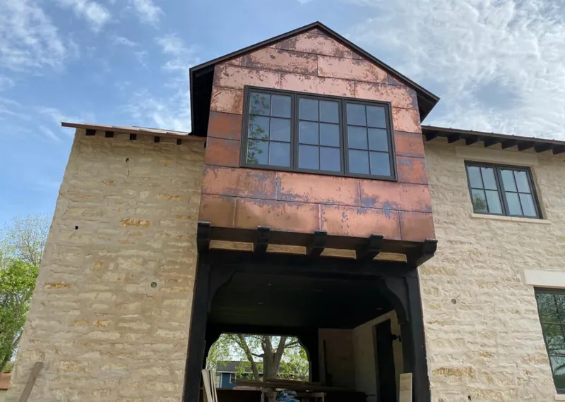 Copper metal panel facade on a stone building for Metal Roof Coating in Guthrie