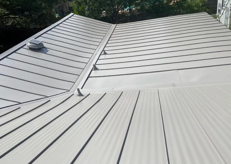 Solar attic fan installed on a metal roof for Roof Ventilation in Guthrie